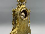 a gold clock that is sitting on a table