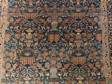 an antique persian rug with blue and orange colors