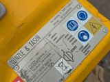 a close up of a yellow fire hydrant with a sticker on it