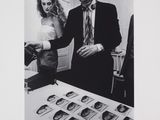black and white photograph of a man and a woman looking at pictures