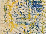 a close up of a piece of paper with blue and yellow paint on it