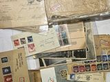 many different types of stamps and envelopes laid out on a table