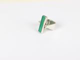 a close up of a ring with a green stone on it