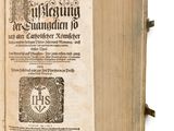 an open book with a picture of a sun on it