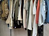 a lot of clothes hanging on a rack in a room