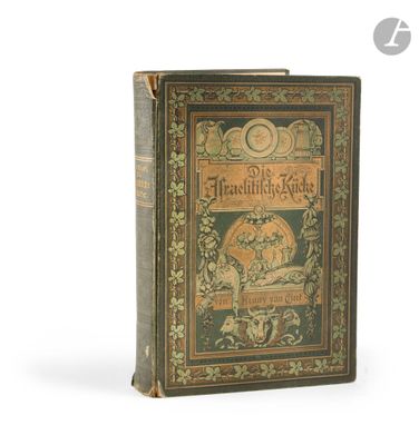 an old book sitting on top of a white table next to a clock