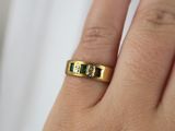 a close up of a person ' s hand with a ring on it