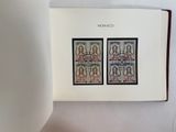 an open book with a picture of a couple of stamps on it