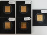 four pieces of gold are on display in a black case