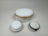 a small white box with a lid and two cookies