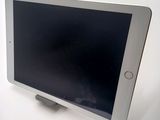 a tablet computer sitting on top of a white table