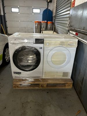 a washing machine sitting on a pallet in a warehouse