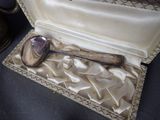 a silver spoon and a silver spoon in a case