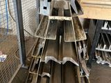 several pieces of metal are stacked on top of each other in a warehouse
