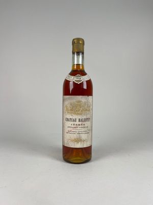 an old bottle of whiskey sitting on top of a white table