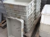 many plastic containers stacked on pallets in a warehouse