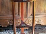 a wooden table with a glass top on a rug