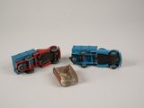 three toy trains sitting next to each other on a white surface