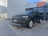 a black jeep compass parked in front of a building