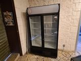 a refrigerator that is sitting in the corner of a room