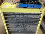 a yellow cart with a bunch of trays on top of it
