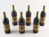 six bottles of wine are lined up in a circle