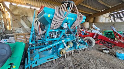 a blue machine that is sitting in the dirt