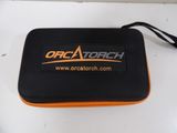 an orange and black case sitting on top of a white table