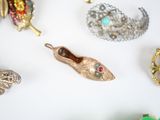 many different types of brooches and jewelry on the table