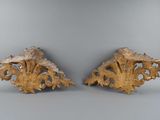 pair of carved wood corals on a gray background