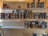 a shelf full of paint and other items in a room