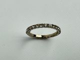 a close up of a diamond ring on a white surface