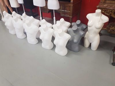 a lot of mannequins that are lined up on the floor