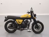a yellow and black motorcycle parked in a white room