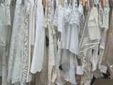 a lot of clothes hanging on a rack in a room