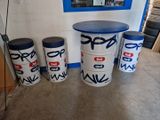 three white barrels with blue lids sit in front of a blue and white wall