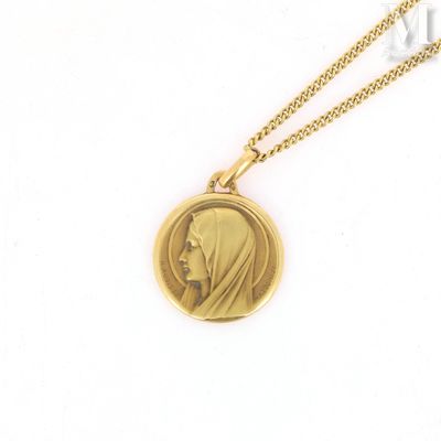 a close up of a gold locke with a woman ' s face on it