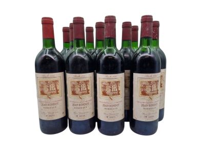 six bottles of red wine are lined up in a row