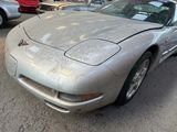 a silver sports car parked on the side of the road