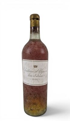 a bottle of wine sitting on top of a white table