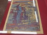 a picture of a painting on a table with a red cloth
