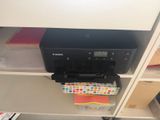 a printer that is sitting on a shelf in a room
