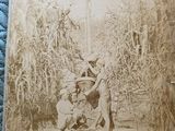an old photo of a man and a woman in a field