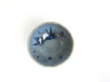 a small bowl with a blue and white design on it
