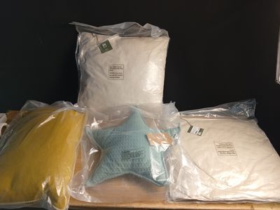 many bags of pillows and pillows on a table