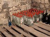 many bottles of alcohol sitting on pallets in a room