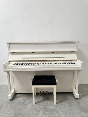an image of a white piano sitting next to a bench