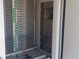 a room that has a door open and a rack in it
