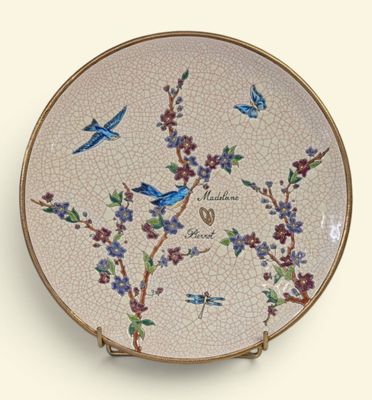 a decorative plate with birds and flowers on it