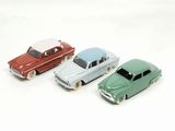several toy cars are lined up in a row on a white surface